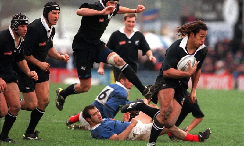All Black Tana Umaga heads for the tryline as Norm Maxwell skips over the beaten French defence during the test at Athletic Park, Saturday. The All Blacks won 547. (Photo by Phil Walter/Getty Images)