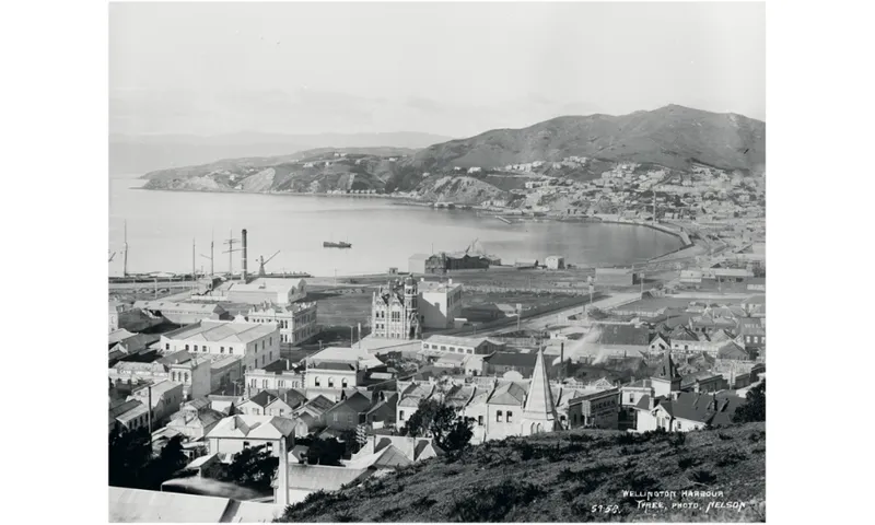 A black and white photo looking down over Wellington harbour. It shows how buildings were laid over reclaimed land.