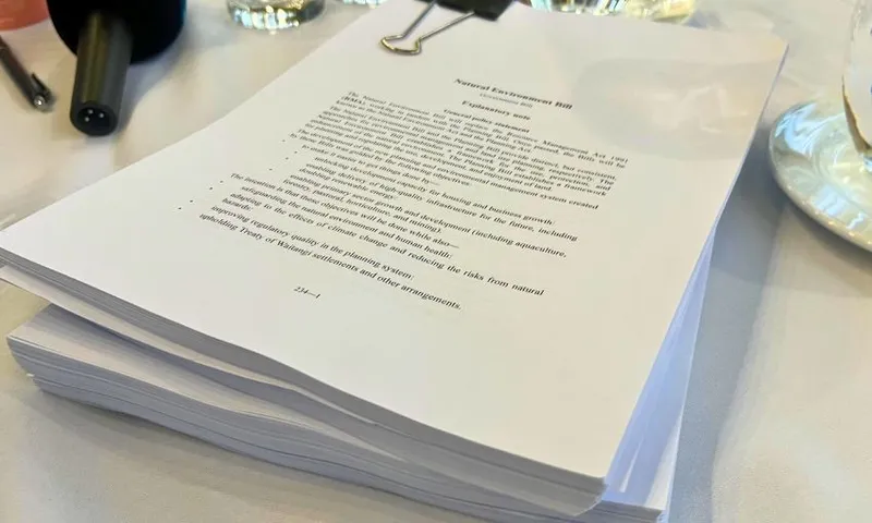 Stacks of hundreds of pieces of paper sit on a table.