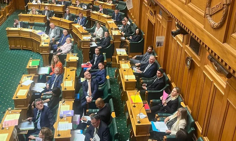 Ministers and MPs sitting on the government side of the House look up as pro-Palestine leaflets fall into the debating chamber.