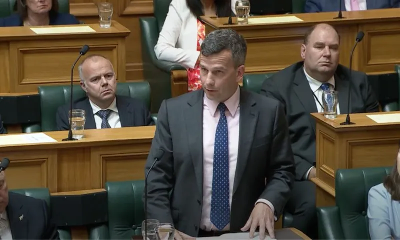 David Seymour stands at his bench in the House, speaking.