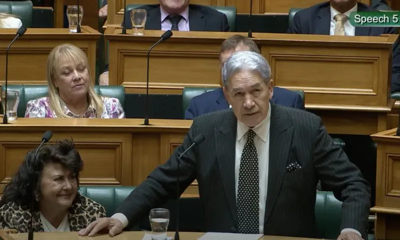 Winston Peters, with arms stretched across his bench, speaks in the House.