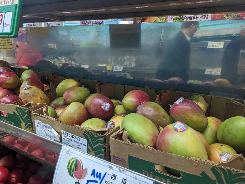mangoes on a shelf in a supermarket, red skins with green and yellow