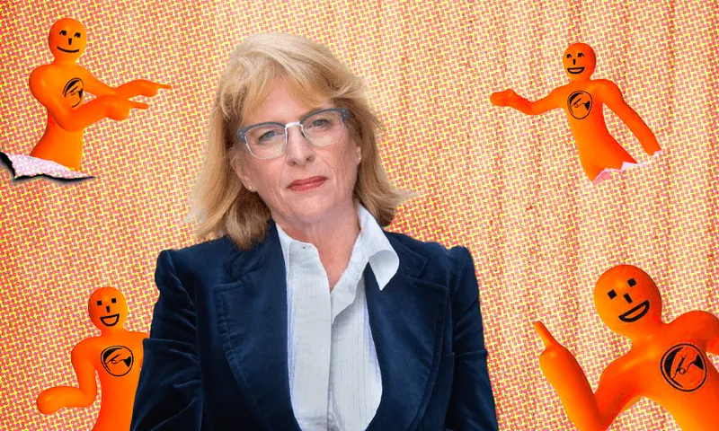 a white blonde woman in formal business dress surrounded by 'orange guy' mascots
