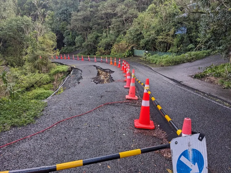 a section of damaged road reduced to one lane near Tititrangi