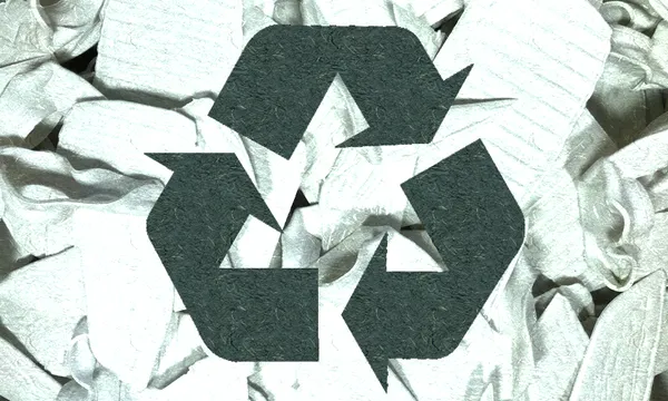 the recycling sign that is green-tinted