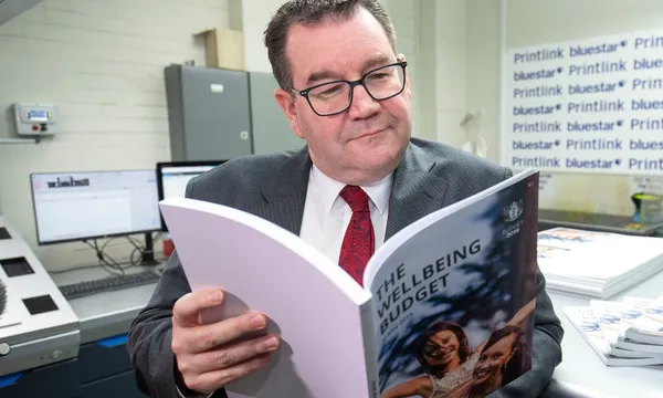 Grant Robertson with wellbeing budget hagen hopkins getty