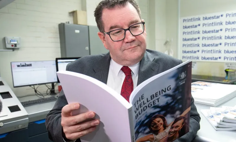 Grant Robertson with wellbeing budget hagen hopkins getty