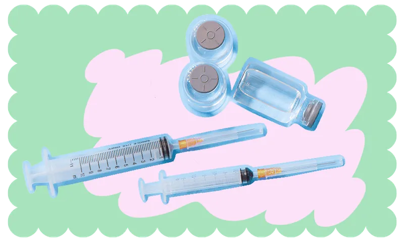 Covid-19 vaccine syringes and vials atop a light pink and green background.