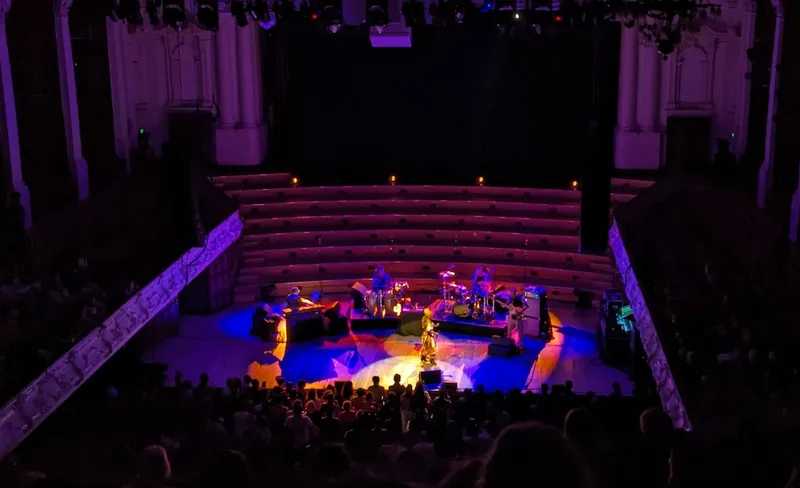 mottled blue and orance light on a dark stage