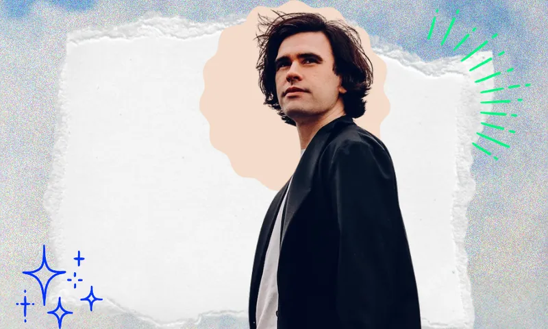 a man with brown hair and blue jacket gazing into the distance