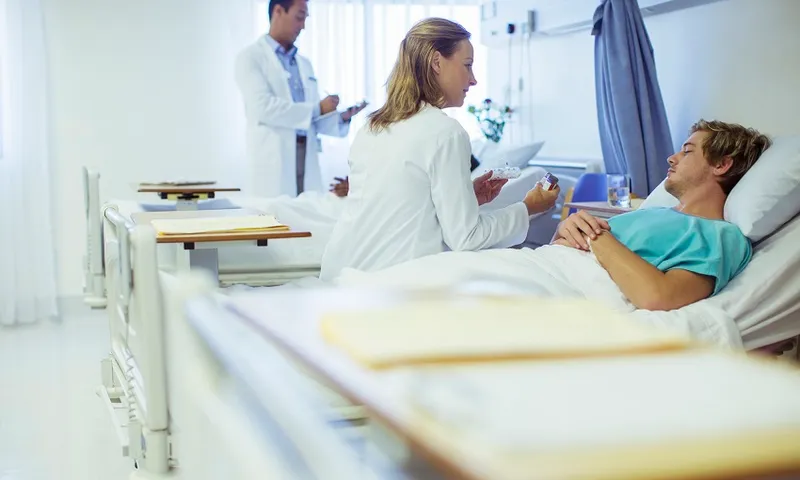 Doctor talking to patient in hospital bed