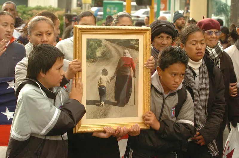 A group of students hold a famous pictur