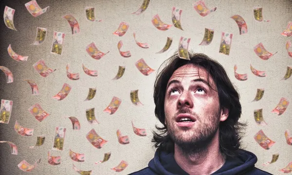 man with money notes falling on him