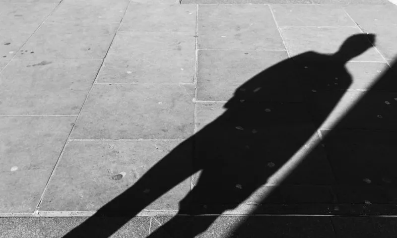 High angle view of man shadow on footpath by Oxford Street