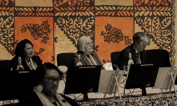 pacific tapa cloths with three people siting at desks in front of them