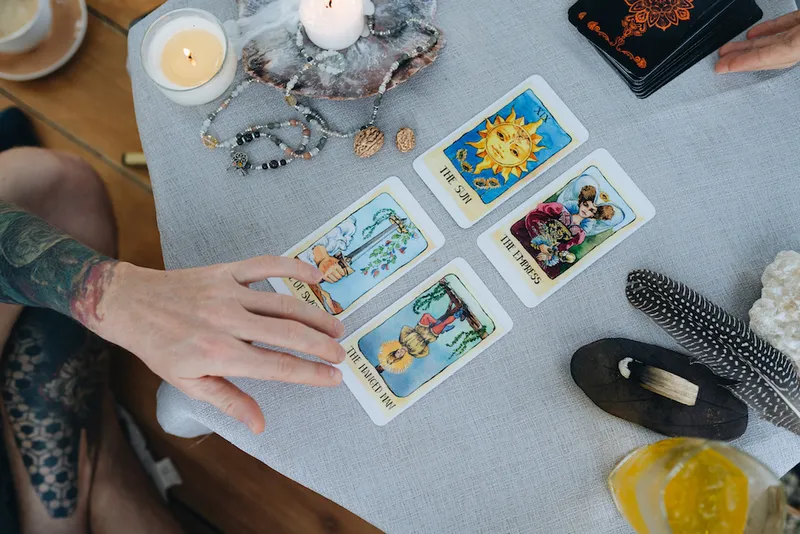 A bald woman reading tarot