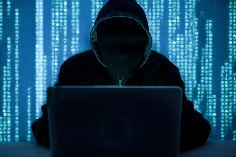a person wearing a hoodie with lines of code between them