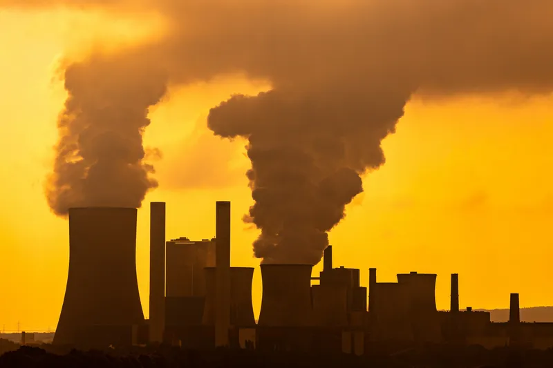 Smoking power station at sunset