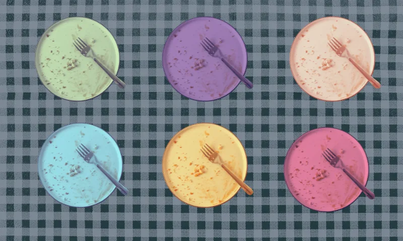 Six colourful plates with forks rest on a blue and white checkered tablecloth. Each plate is a different pastel colour — green, purple, orange, blue, yellow, and pink – and has food crumbs on it.