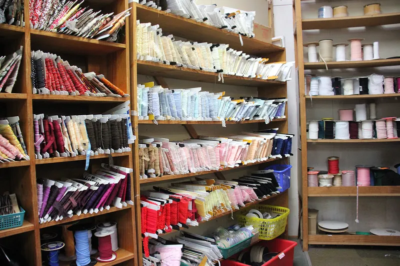 Trims, lace edging and webbing stacked on shelves