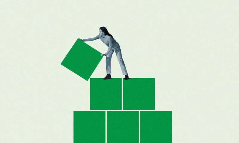 Young woman building green block pyramid