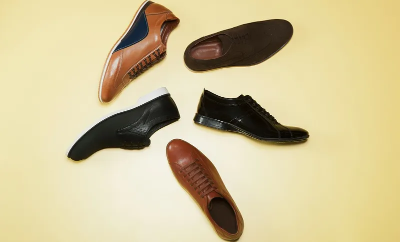 Various Shoes Over Beige Background