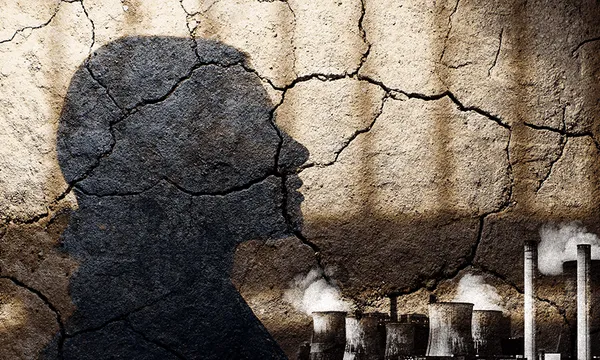 cracked earth with a shadow of a person's head and some big emitting chimneys looking THREATENING