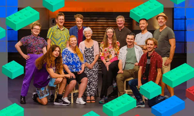 Twelve adults sit and smile at the camera
