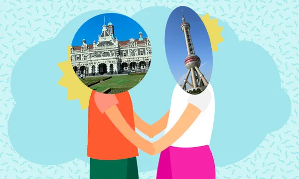 a zany blue background with a sort squiggly shape and two cartoon figures holding hands except one has the dunedin railway station for a head and the other has the iconic shanghai pearl tower