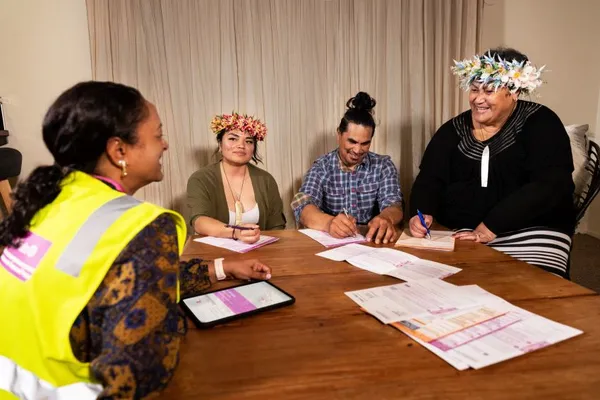 Census collector helping out a Pacific family