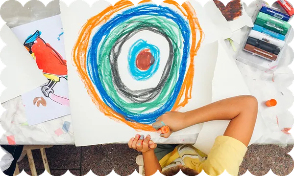 a wavy border around a top-down photo of a kid drawing