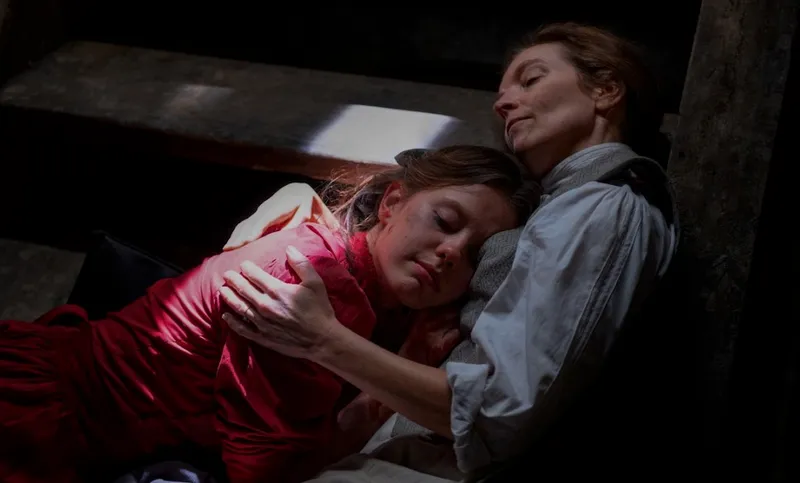 Mia Goth and Tandi Wright embrace in the film Pearl.