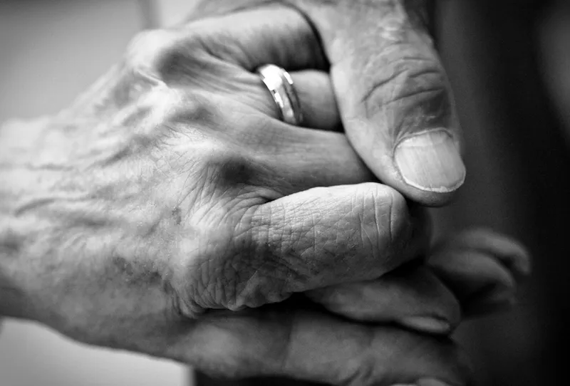 black and white photo of hands holding