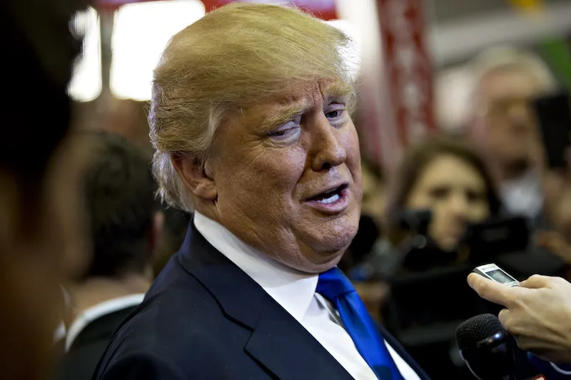 Close up of Donald Trump talking and clearly loving himself talking, into a dictaphone held by a reporter