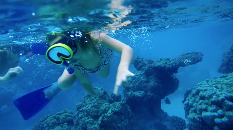 A girl enjoys the snorkelling in Rarotonga.
