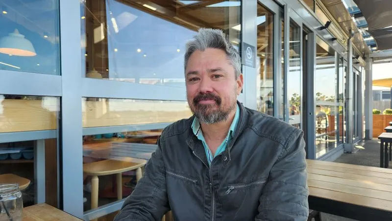 Sebastian Hurrell sitting at an Auckland cafe
