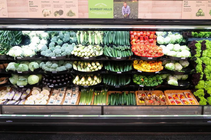 a supermarket with lots of veges allpiled neatly without any of those flimsy plastic bags