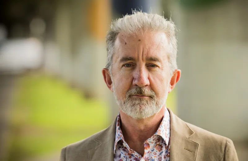 Nigel Latta with a jacket and grey hair.