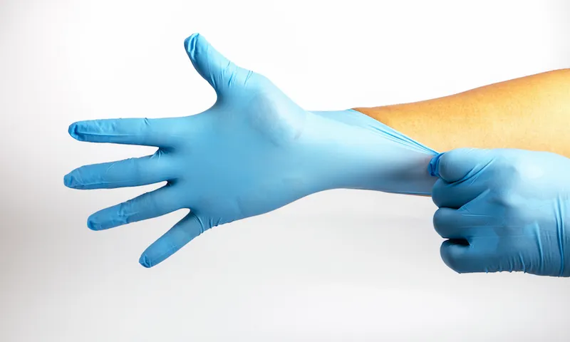 Human holding Variation of Latex Glove, Rubber glove manufacturing, human hand is wearing a medical glove, glove, isolated