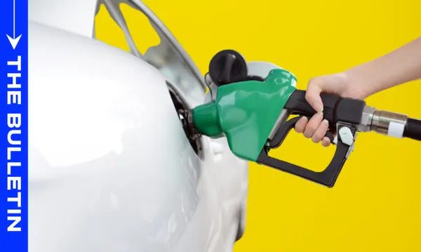 A person’s hand holds a green gasoline pump nozzle, fueling a white car against a bright yellow background. A blue vertical banner on the left reads "THE BULLETIN.