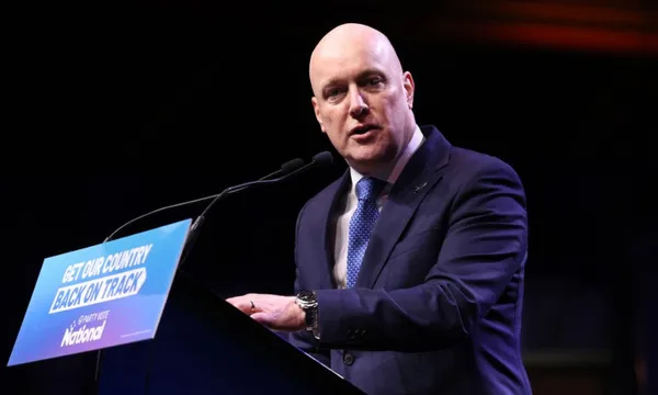 a bald man in front of a national sign