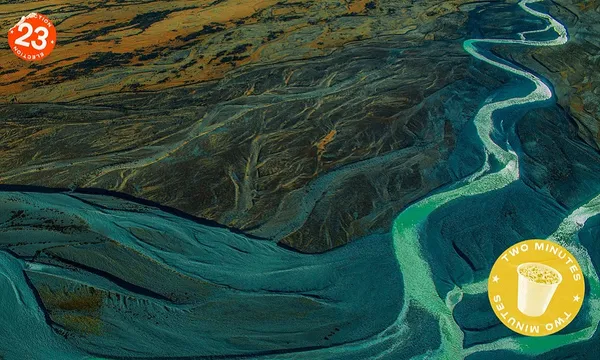 a shiny river with a "policy n 2 minutes sticker on the image a braided south island kinda wide blue river
