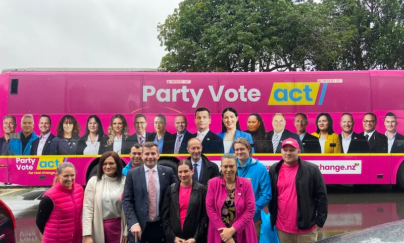 David Seymour and other Act candidates in front of a big pink bus