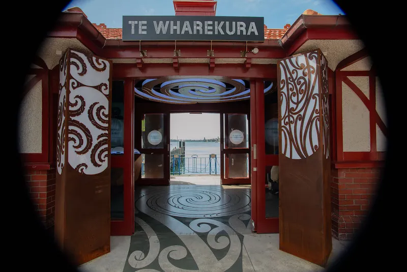 Two of the entrance pou and the takarangi.