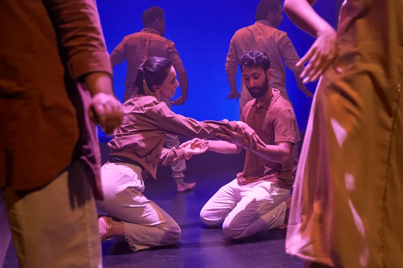 a man and woman wearing brown shirts and white pants