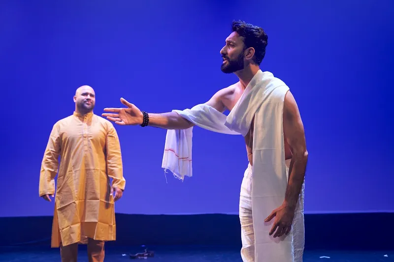 a blue background with two brownskinned actors in dramati poses