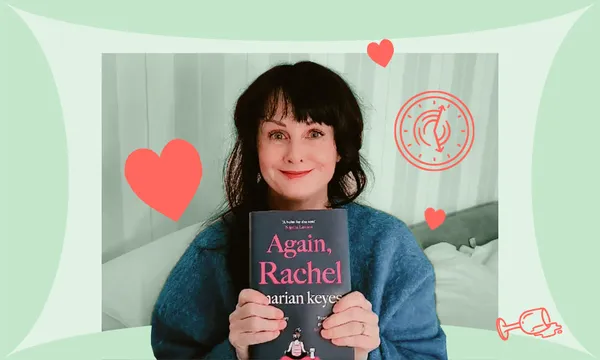 Middle-aged woman, black hair, big smile, pale Irish skin, beaming and holding a copy of a book .