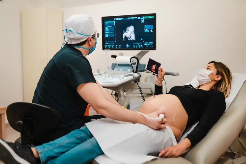 Pregnant woman watching her baby on the ultrasound