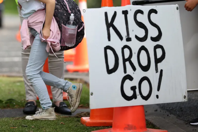 AUCKLAND, NEW ZEALAND - NOVEMBER 17: Kaipara Flats School welcomes children as they return for their first day at school since Auckland went into lockdown 92 days ago on November 17, 2021 in Auckland, New Zealand. 200,000 school students from years 0 - 10 are able to return to classrooms across the Auckland region from today under eased COVID-19 restrictions. New rules set out by the Education Ministry include keeping children in separate, stable groups that don't mingle, using physical distancing where practical, and requiring faces masks inside for children in Year 4 and above. The rules apply to all schools in COVID-19 Alert Level 3 regions. (Photo by Fiona Goodall/Getty Images)